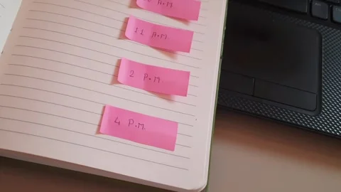 Scheduling Meeting Time with Sticky Notes on Daily Planner Notebook Video stock 335373803