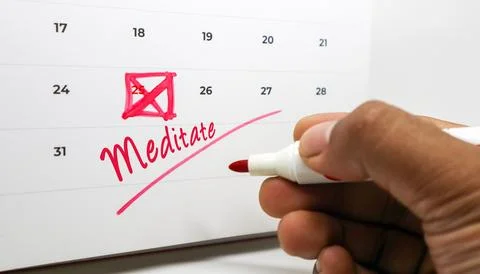 Scheduling a mindful moment a hand marks Meditate on a calendar, symbolizin.. Stock Photos