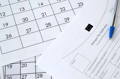 Schengen Visa application form and blue pen on paper calendar page Stock Photos