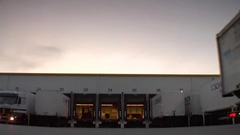 Schenker Trucks at Industrial Loading Dock During Sunset Video stock 317554652