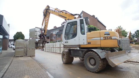 Schimmert, The Netherlands - August 3, 2017 - Excavator Putting Down Pallets Stock Footage 129398719