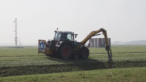 Schiphol, The Netherlands - August 29, 2017 - Tractor With Spraying Arm Stock Footage 129398663