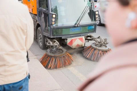 Schmidt cleaning machine sweeps road asphalt in city street, sweeper car Stock Photos