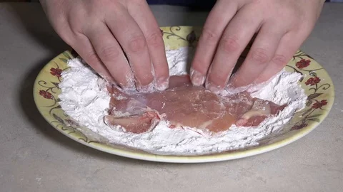 Schnitzel rolled in flour Stock Footage 106648224
