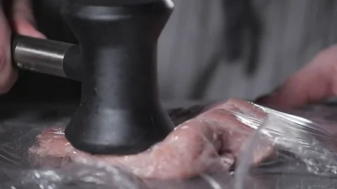 Schnitzel wiener. Chef cooking on kitchen restaurant. Tenderizing the meat with Stock Footage 84959620