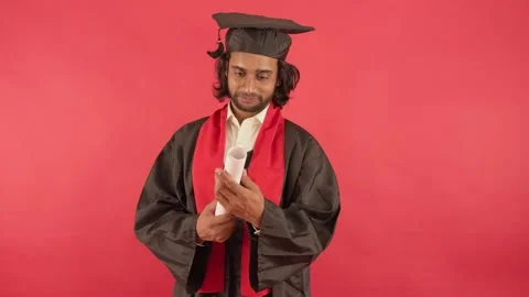 Scholar in convocation robe clutches degree with emotion Stock Footage 314178926