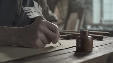 Scholar sketching a geometry drawing with a feather pen at a desk Stock Footage 338991628
