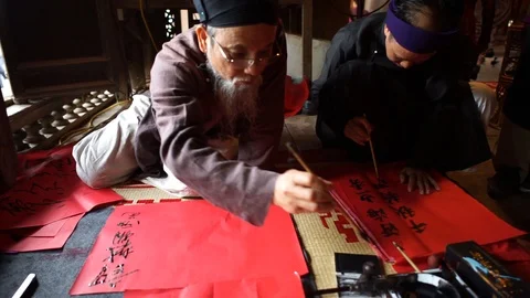 Scholar writes Chinese calligraphy characters Stock Footage 87488806