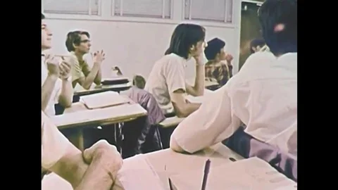 A scholarly male high school student participates in a math test with a remote Stock Footage 115371153
