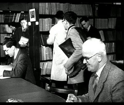 Scholars study data and maps on sea life, Scotland UK 1950 Stock Footage 131078382