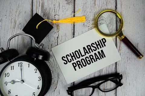Scholarship Program text on paper card with alarm clock and magnifying glas.. Stock Photos
