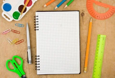 School accessories and checked notebook on wood Stock Photos
