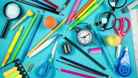 School accessories completely fill frame and move making empty blue background. Stock-Footage 202219638