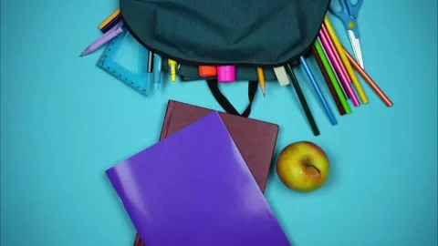 School accessories fall from the backpack in a row below. Stop motion Video stock 244536326