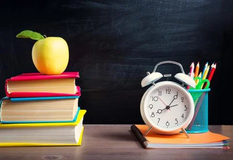 School accessories on the table with blackboard background Stock Photos