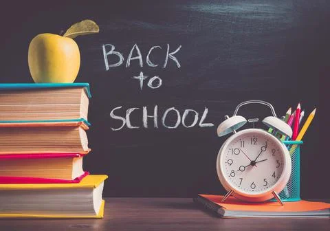 School accessories on the table with blackboard background Stock Photos
