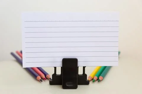 School accessories on a White table, sheet of paper and pencils Foto stock