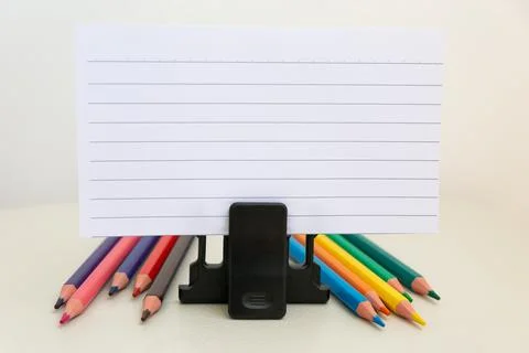 School accessories on a White table, sheet of paper and pencils Stock Photos