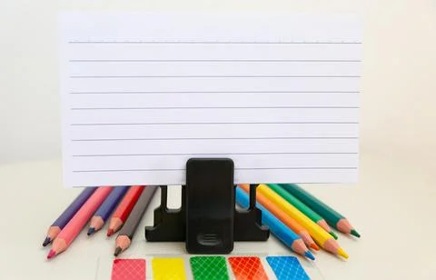School accessories on a White table, sheet of paper and pencils Stock Photos
