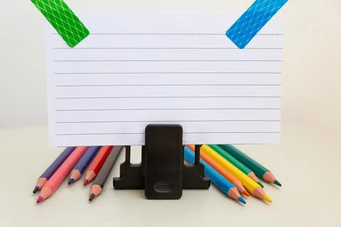 School accessories on a White table, sheet of paper and pencils Foto stock