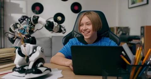 A school-age boy develops a passion for electronics. The child assembles a robot 動画素材 196008073