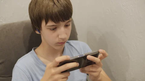 School-age child playing mobile games Vídeo Stock 246908956