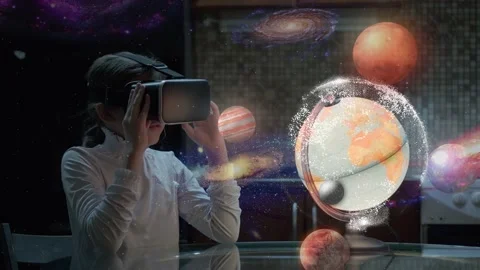 School-age child wears virtual reality glasses and examines a hologram of the Video stock 142864030