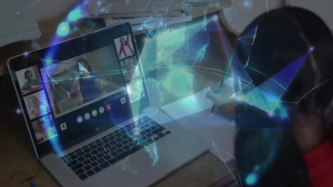 School-age girl writing notes during online class, polygons glowing into Stock Footage 311505619