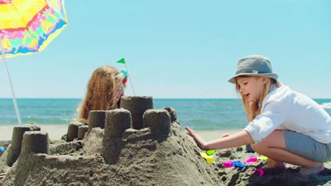 School-age siblings playing with sand Video stock 155873878