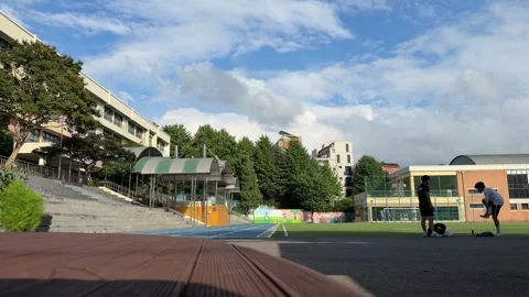 School Athletic Field and Running Track Under Wide Blue Summer Sky 库存影片 342738424