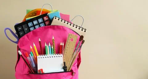 School background with a pink backpack, school stationery and an empty space Stock-Fotos