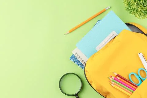 School backpack with educational supplies. Stock Photos