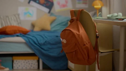 School Backpack Hanging on Chair in Empty Childs Room Stock Footage 337561122