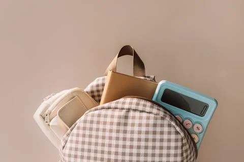 School backpack with notebook and blue calculator, stylish back to school Stock Photos