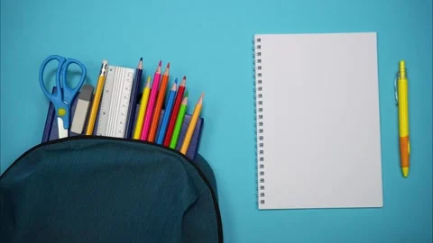 From the school bag appear books, scissors, pencils and ruler. Stop motion Video stock 248383219