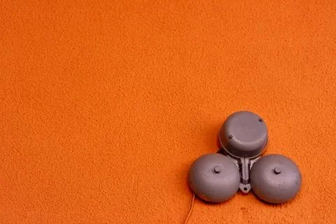 School bell on the orange background. Copyspace Stock Photos