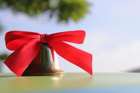 School bell with a red bow close-up. Stock Photos