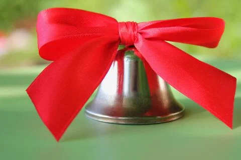 School bell with a red bow close-up. Stock Photos