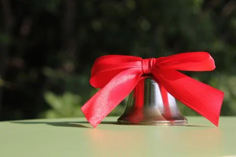 School bell with a red bow close-up. Stock Photos