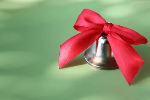 School bell with a red bow close-up. Stock Photos