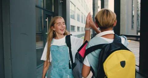 School boy child with backpack alone going running to modern school building a Stock Footage 248614219