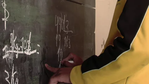 A School Boy Doing Math Problems at Blackboard in Class. Close Up. Stock Footage 235739776