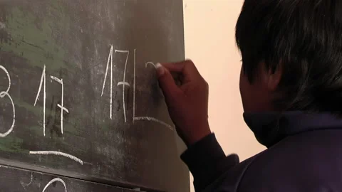 A School Boy Doing Math Problems at Blackboard in Class. Close Up. Stock Footage 235740133