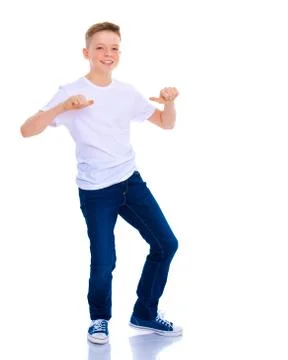 A school boy points to his white T-shirt. Stock Photos