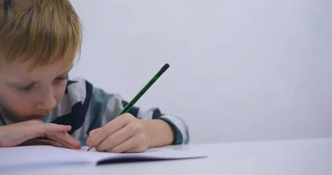 School boy practicing writing the alphabet at home Stock Footage 167795051