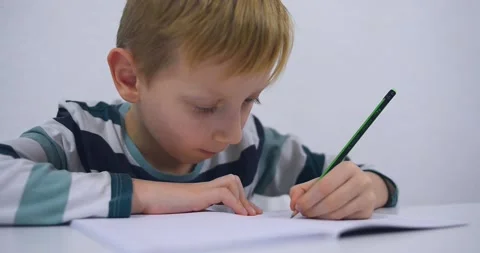 School boy practicing writing the alphabet at home Stock Footage 167795057