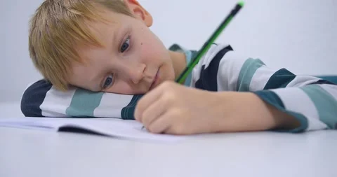 School boy practicing writing the alphabet at home Stock Footage 167795077