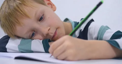 School boy practicing writing the alphabet at home Stock Footage 167795123