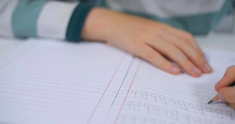 School boy practicing writing the alphabet at home Stock Footage 167795172