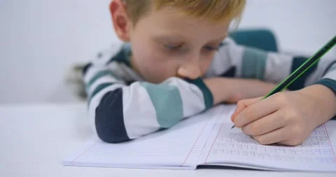 School boy practicing writing the alphabet at home Stock Footage 167795206